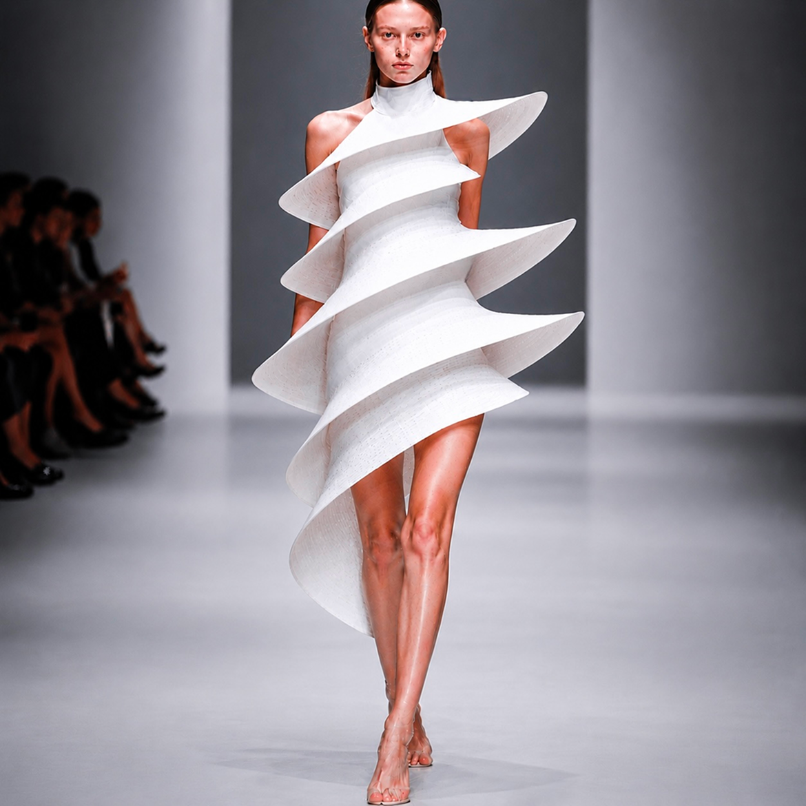 White sculptural runway dress using punch-card textile language.